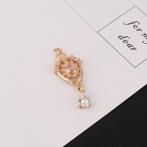 Detailed macro view of a golden vintage crown pendant with teardrop zircon for DIY jewelry