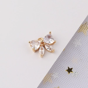 Detalle de colgante de lazo bañado en oro con circonitas para la creación de joyas DIY