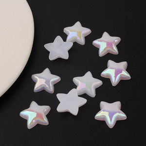 Macro shot of colorful aurora AB coating star-shaped acrylic beads on dark background