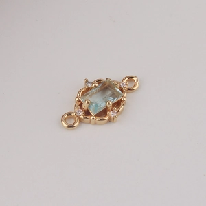 Detail of gold plated rectangular blue zircon connector with double loops for DIY jewelry