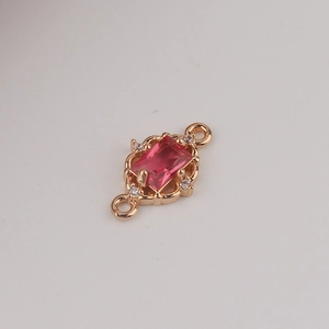 Macro detail of gold-plated rectangular pink zircon connector with micro-pave accents