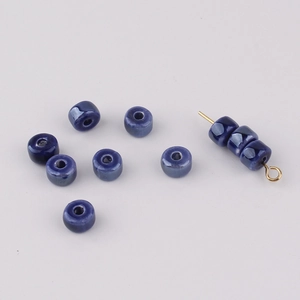 Macro shot of blue kiln-glazed ceramic beads for DIY necklace and bracelet crafting
