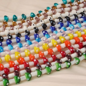 Macro shot of colorful mushroom glass beads with white dots for DIY jewelry making