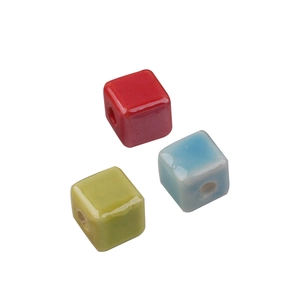 Handmade cream-colored square ceramic beads in red, blue, and green with a glossy finish