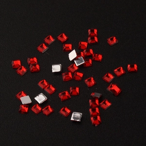 Macro shot of 2mm square red acrylic flatback rhinestones for DIY nail art and crafts
