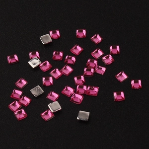 Macro shot of 2mm square pink acrylic rhinestones with silver flat back for DIY nail art