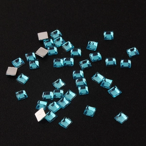 Detailed close-up of 2mm light blue square acrylic rhinestones with silver flat back