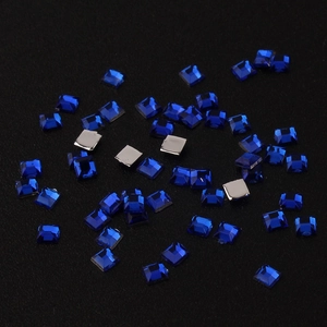Macro detail of 2mm square royal blue acrylic rhinestones with faceted surface