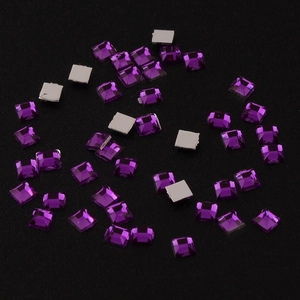 Macro detail of 2mm square purple acrylic rhinestones with flat back and faceted surface