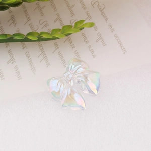 Close-up of iridescent pearlescent resin bow charm for DIY crafts and hair accessories