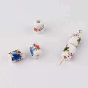 Detailed view of floral cylinder ceramic beads for DIY jewelry making and red cord bracelets