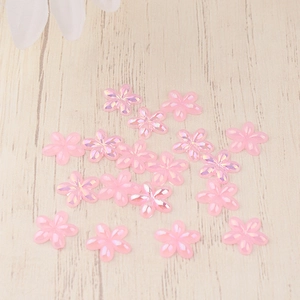 Flat lay of pink resin five-petal flowers with iridescent AB coating for DIY crafts