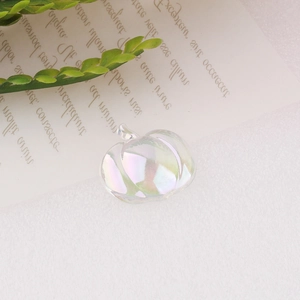 Detailed view of iridescent pumpkin resin charm with pearlescent finish for DIY crafting