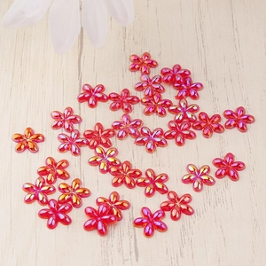 Macro shot of red AB iridescent resin flower charms for DIY crafts and phone case decor