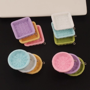Macro detail of mini woven basket charms with metal rings for DIY jewelry making