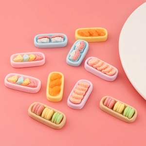 Miniature macaron and cookie resin charms in small trays for DIY phone case decoration