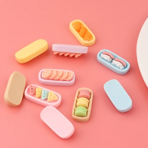Mix of colorful miniature resin sweets including macaroons and sushi rolls for DIY crafts