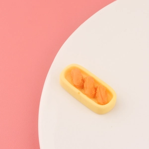 Macro shot of miniature Japanese sushi toy set on a yellow tray for DIY crafts