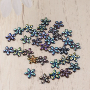 Macro shot of colorful iridescent resin flower beads for DIY crafts and nail art decor