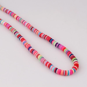 Close-up of vibrant mixed color polymer clay heishi beads for DIY jewelry making