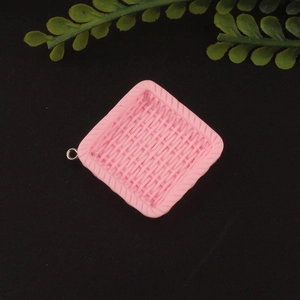 Detailed macro view of pink square resin pendant with woven texture for DIY jewelry