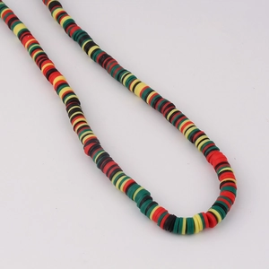 Close-up of colorful polymer clay disc beads in red, yellow, and green for DIY jewelry