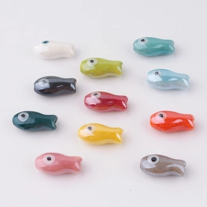 Hand-painted ceramic fish beads in eleven vibrant colors for DIY jewelry and crafts