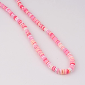 Detail of 6mm pink and orange heishi clay bead strands for DIY jewelry making