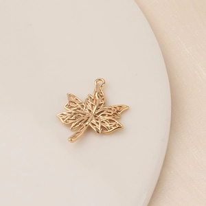 Detailed view of hollowed-out golden maple leaf pendant for DIY jewelry accessories