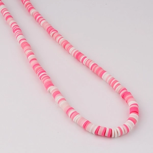 Close-up of pink and white polymer clay Heishi beads for DIY jewelry making