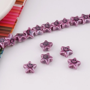 Macro shot of purple ceramic star beads with smiley face pattern for DIY jewelry