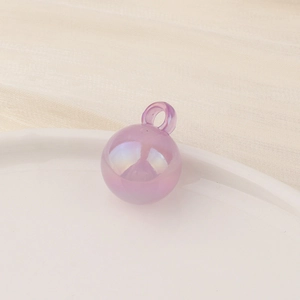 Macro shot of a purple translucent round pendant bead with AB iridescent coating effect