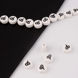 Detailed macro shot of white ceramic Leo zodiac beads for DIY bracelet jewelry making
