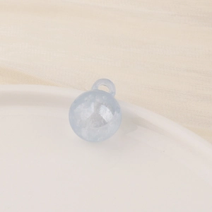 Close-up of a light blue translucent resin pendant bead with internal cloud texture