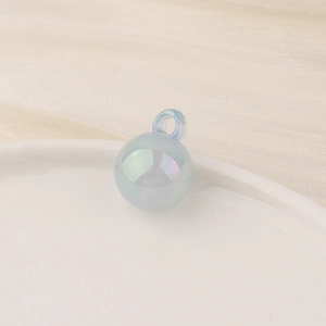 Close-up of a blue iridescent spherical charm bead with integrated ring for DIY jewelry