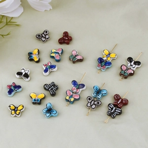 Detail showing hand-painted butterfly ceramic beads for DIY jewelry making and crafts