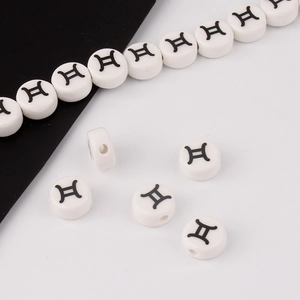 Macro shot of white ceramic Gemini zodiac beads for DIY jewelry making and bracelets