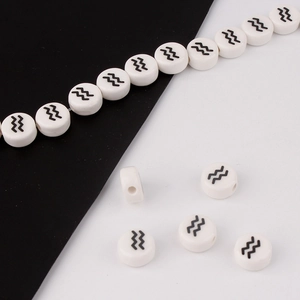 Detailed view of white ceramic Aquarius zodiac beads for DIY bracelet jewelry making