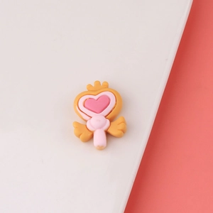 Detail of pink resin heart charm with crown and wings for DIY hairclip accessories