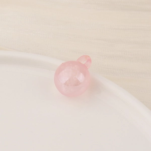 Close-up of a translucent pink candy-colored resin bead pendant for DIY jewelry making