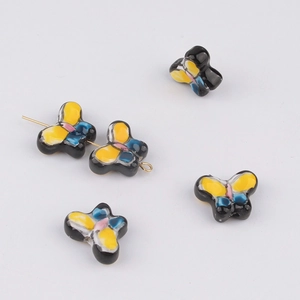 Detail of butterfly ceramic beads with hand-painted patterns for DIY jewelry making