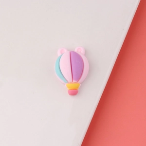 Detailed view of a pastel resin hot air balloon charm with bear ears for DIY crafting projects