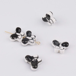 Detailed macro view of butterfly ceramic beads with black and white marble glaze finish