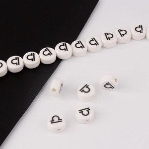 Detailed view of white ceramic Libra zodiac beads for DIY handmade jewelry crafting
