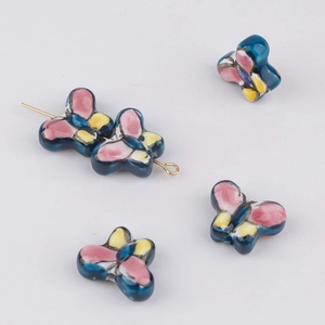 Detailed macro view of colorful butterfly ceramic beads for DIY jewelry making