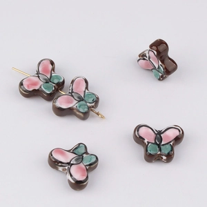 Close-up of hand-painted ceramic butterfly beads for DIY jewelry making and bracelets