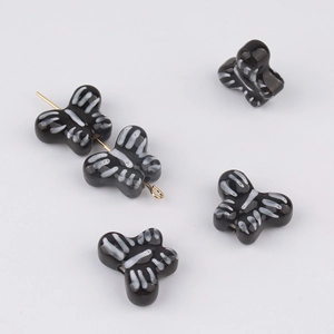 Macro detail of butterfly ceramic beads with white stripes for DIY jewelry making