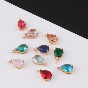 Detailed view of teardrop crystal charms in various colors with gold-plated metal borders