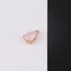 Macro shot of pink teardrop crystal pendant with gold-plated four-claw setting for DIY jewelry