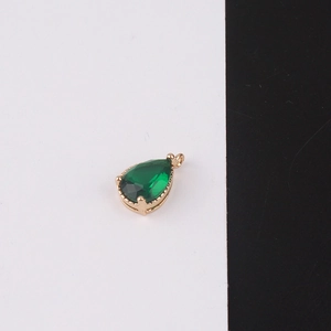 Detail of pear-cut emerald gemstone pendant with gold plated teardrop claw setting